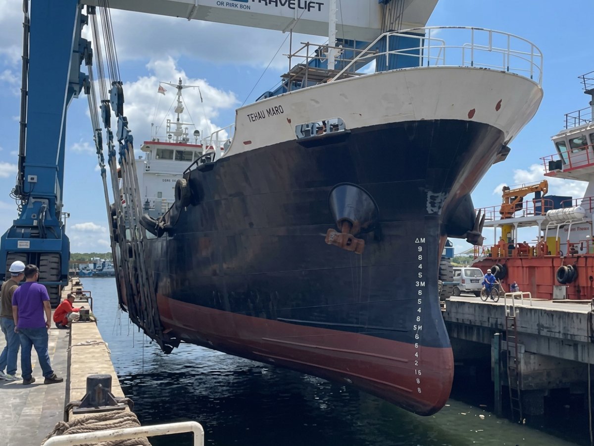 Survey team inspecting a vessel bottom in dry dock