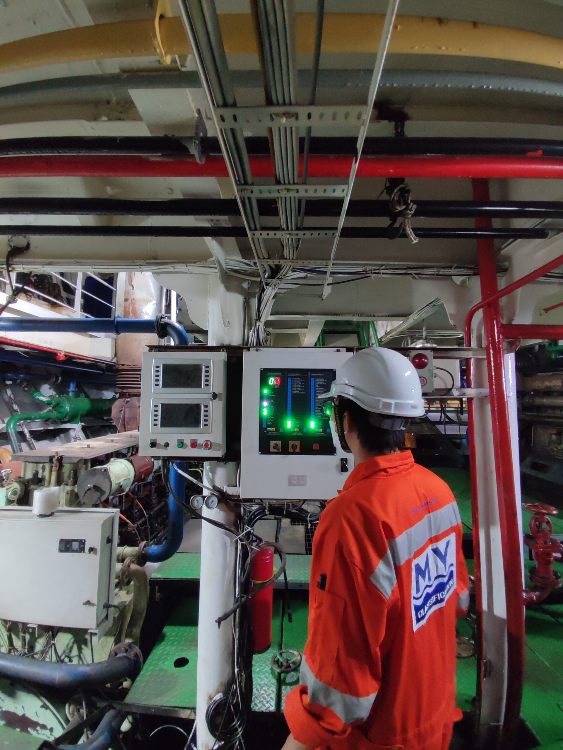 Surveyor inspecting machinery in the engine room during an annual survey